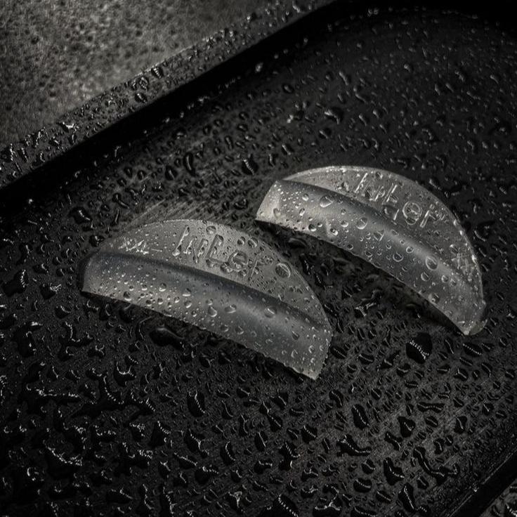 Lash lift and tint tools with water droplets, enhancing natural lashes.